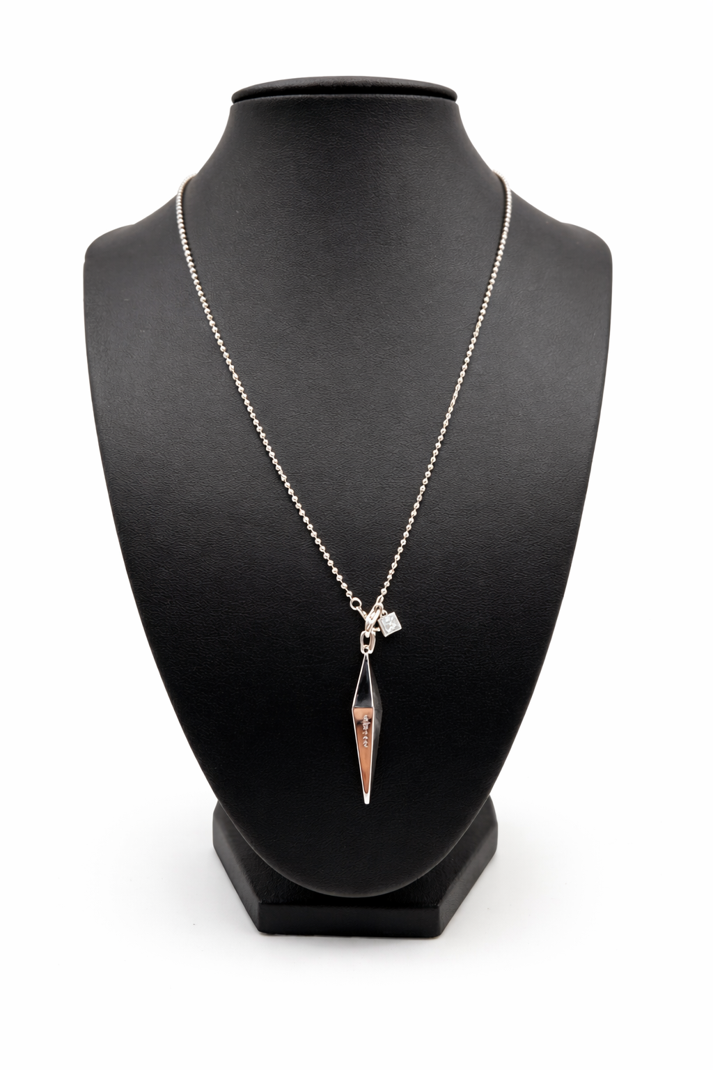 Necklace with a pendant on a black mannequin bust against a white background