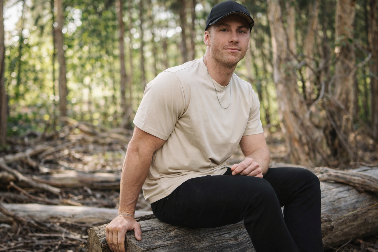 Male model wearing MRVP & Co men’s jewellery — a solid sterling silver chain — styled in a casual outdoor bush setting.