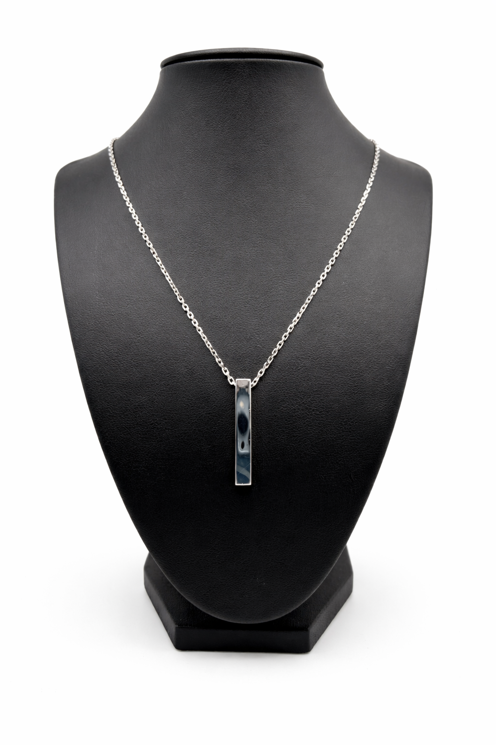 Necklace with a pendant on a black mannequin bust against a white background